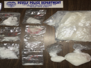 Sign reading "Let's work together to stop drug abuse" surrounded by drugs.